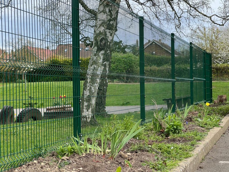 Green mesh fence around a school playing field