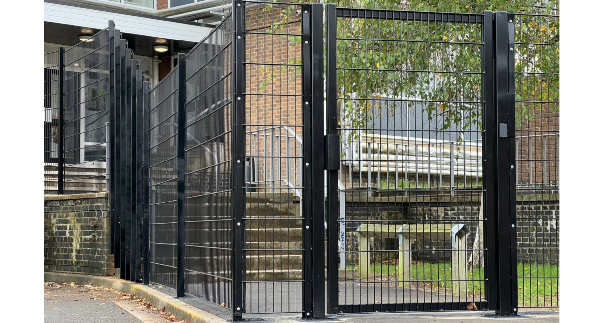A black pedestrian gate with intercom access control