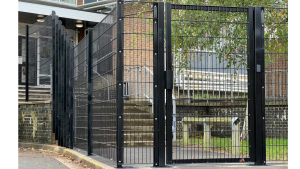 A black pedestrian gate with intercom access control