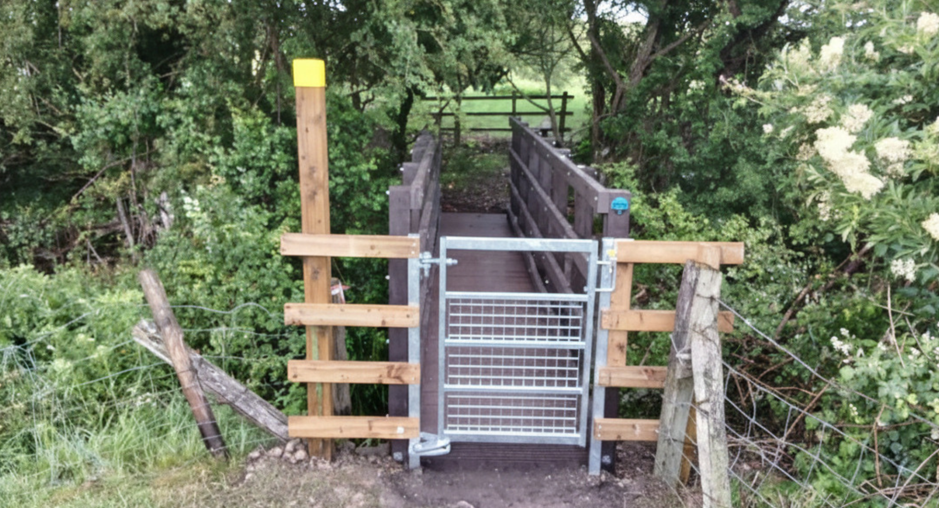 A steel gate in front of a newly installed pedestrian bridge in Chesterton, Warks