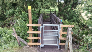 A steel gate in front of a newly installed pedestrian bridge in Chesterton, Warks