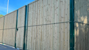 Green security mesh fence panel with timber slats in to form to provide privacy