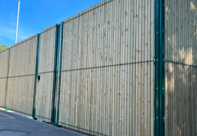 Green security mesh fence panel with timber slats in to form to provide privacy
