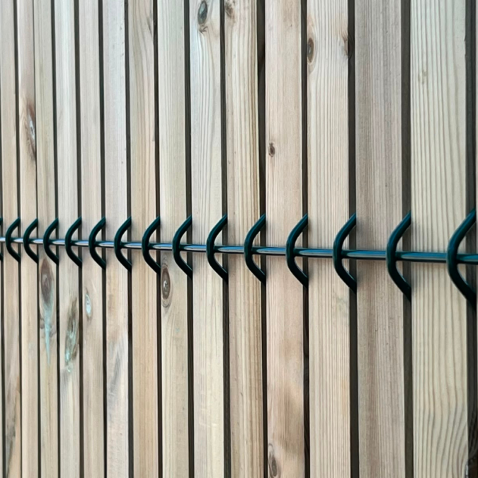 Timber slats in green security mesh