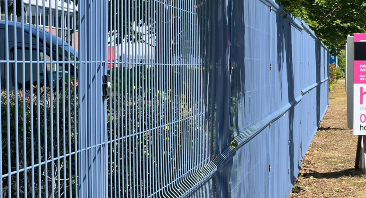 Commercial property with blue mesh fencing