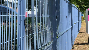 Commercial property with blue mesh fencing