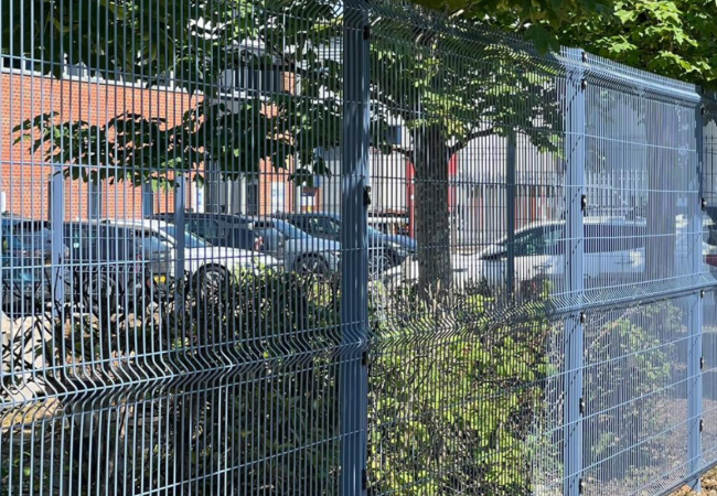 Blue mesh fencing around an industrial property in Castle Donington