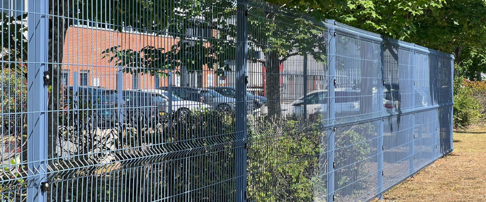 Blue mesh fencing around an industrial property in Castle Donington
