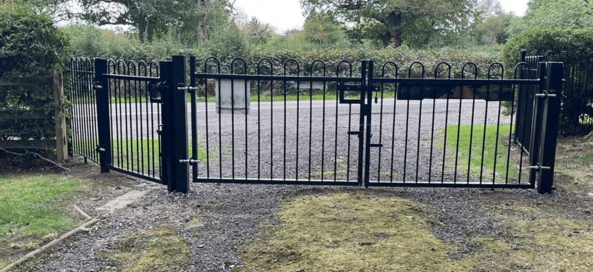 a pair of black gates at the entrance to the cemetery