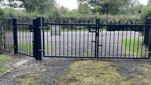 a pair of black gates at the entrance to the cemetery