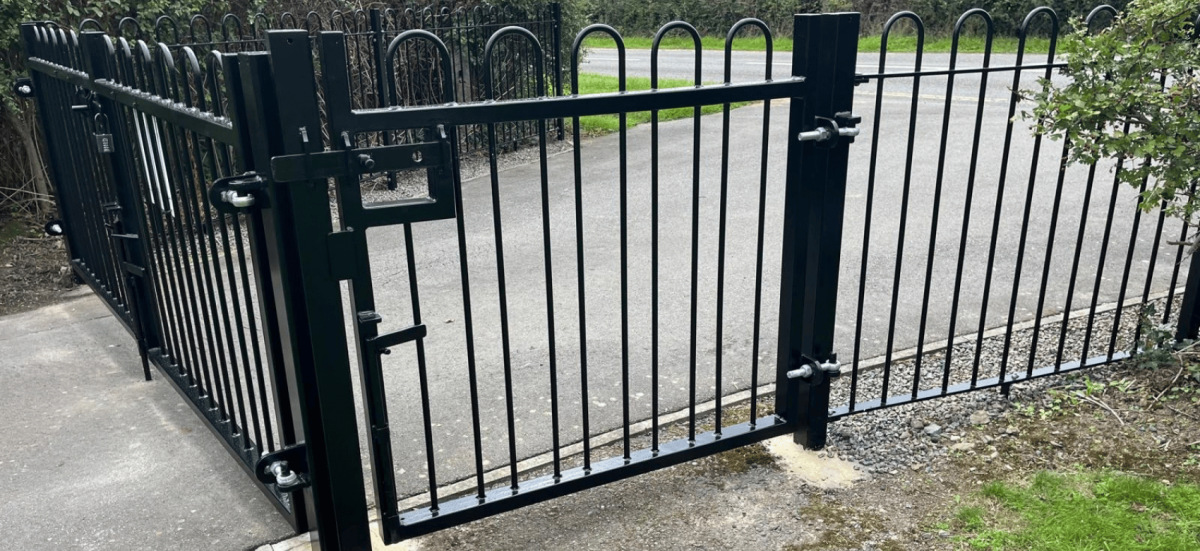 A black steel pedestrian gate at the cemetery in Newtown Linford