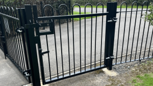 A black steel pedestrian gate at the cemetery in Newtown Linford